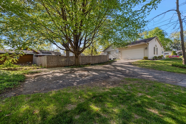 2015 Hazel Ave, Wixom, MI 48393 - view of side of home featuring asphalt driveway and an attached garage