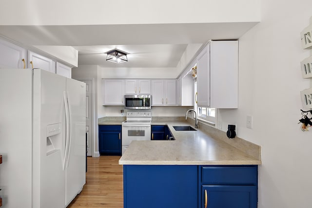 2015 Hazel Ave, Wixom, MI 48393 - kitchen featuring white appliances, blue cabinets, a sink, and light wood finished floors