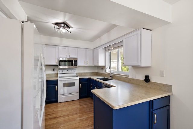 2015 Hazel Ave, Wixom, MI 48393 - kitchen featuring white appliances, blue cabinets, a sink, and white cabinetry