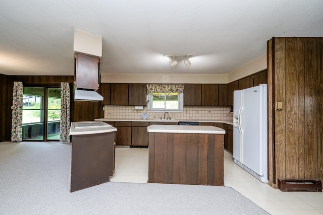 5575 Meadowbrook Rd, Eau Claire, MI 49111 - kitchen featuring white refrigerator with ice dispenser, a sink, a center island, dark brown cabinetry, and light countertops