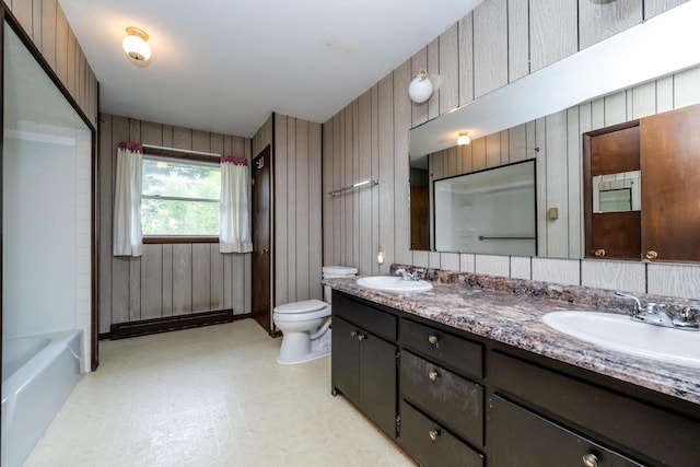 5575 Meadowbrook Rd, Eau Claire, MI 49111 - full bath featuring toilet, double vanity, wood walls, and a baseboard radiator
