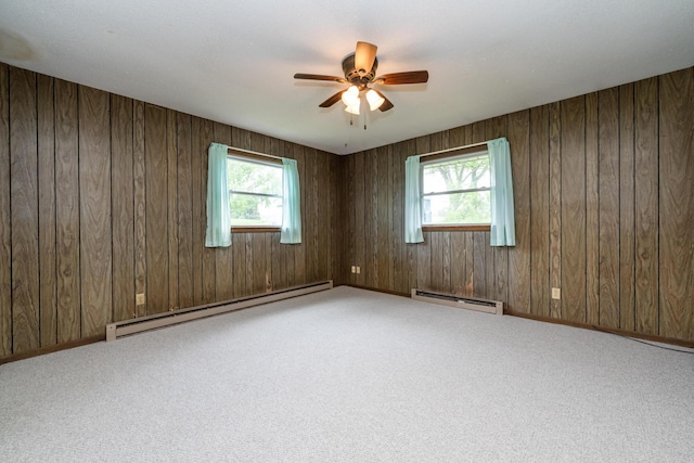 5575 Meadowbrook Rd, Eau Claire, MI 49111 - carpeted spare room with baseboard heating, a baseboard radiator, ceiling fan, healthy amount of natural light, and wood walls