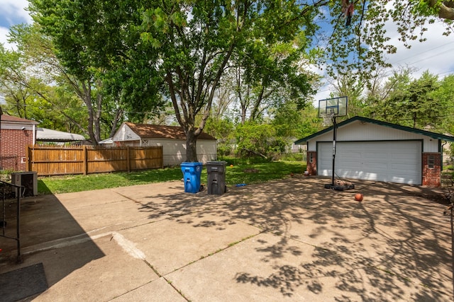 29660 Avondale St, Inkster, MI 48141 - view of patio with fence, an outbuilding, and a detached garage
