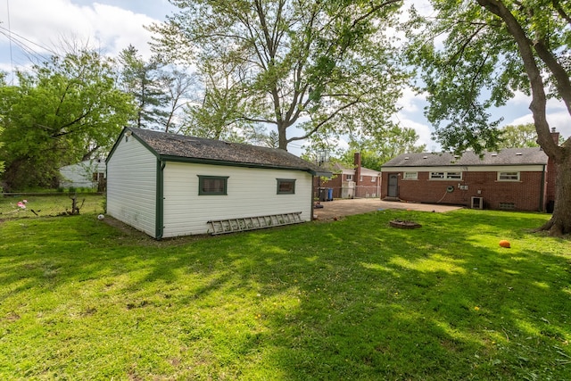 29660 Avondale St, Inkster, MI 48141 - view of yard featuring a patio area, a fire pit, and an outbuilding