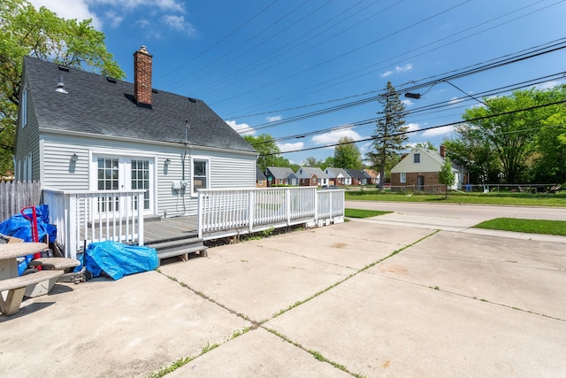 26613 W Hills Dr, Inkster, MI 48141 - rear view of property with a wooden deck, a shingled roof, and a chimney