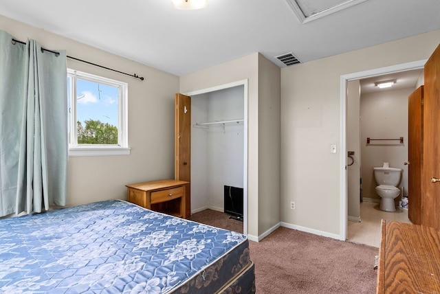 carpeted bedroom with a closet and baseboards
