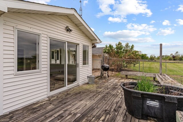 wooden terrace featuring fence