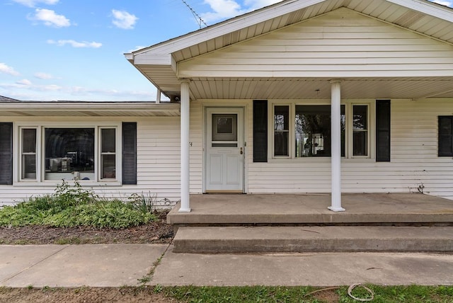 view of exterior entry with covered porch