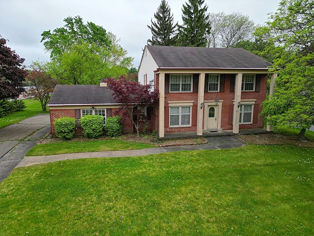 4003 Old Dominion Dr, West Bloomfield, MI 48323 - view of front of house featuring brick siding, a front yard, and roof with shingles
