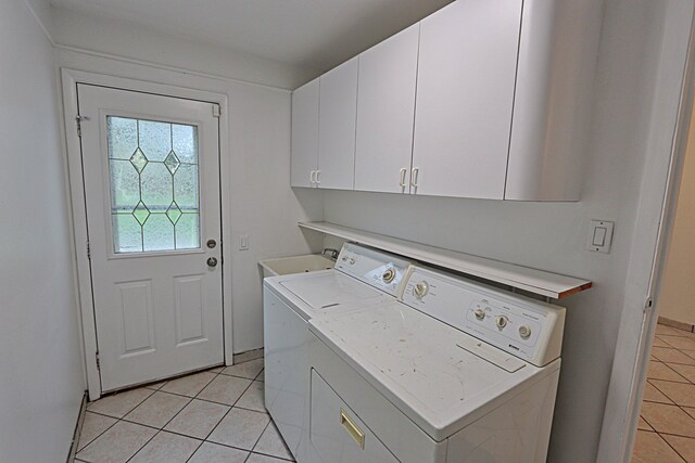 4003 Old Dominion Dr, West Bloomfield, MI 48323 - washroom featuring light tile patterned flooring, cabinet space, and washing machine and clothes dryer