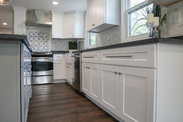 278 W Saint Clair St, Romeo, MI 48065 - kitchen featuring appliances with stainless steel finishes, wall chimney exhaust hood, recessed lighting, white cabinets, and decorative backsplash