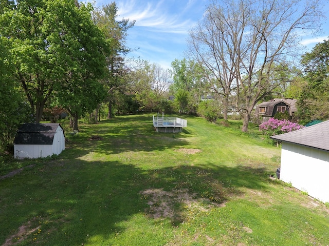 278 W Saint Clair St, Romeo, MI 48065 - view of grassy yard featuring a storage unit and an outbuilding