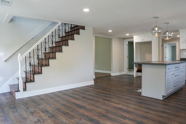 278 W Saint Clair St, Romeo, MI 48065 - kitchen featuring dark wood-style floors, baseboards, recessed lighting, and dark countertops