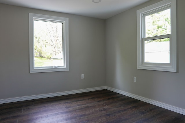 278 W Saint Clair St, Romeo, MI 48065 - spare room with dark wood-type flooring, healthy amount of natural light, and baseboards