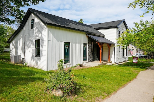 278 W Saint Clair St, Romeo, MI 48065 - view of home's exterior featuring a yard, board and batten siding, and cooling unit