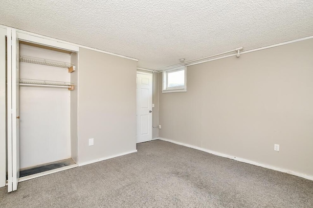unfurnished bedroom with carpet floors, a closet, a textured ceiling, and baseboards