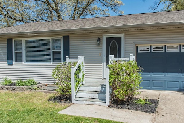 property entrance with roof with shingles and a garage