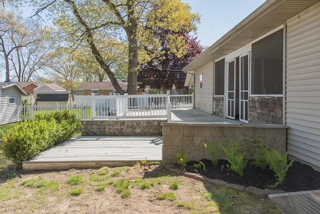 wooden terrace featuring fence