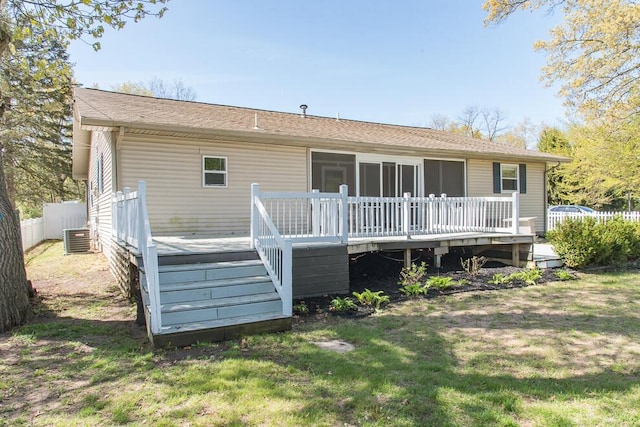 rear view of house with central AC unit, a deck, roof with shingles, and stairway