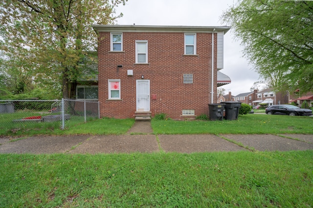 rear view of house featuring brick siding and entry steps