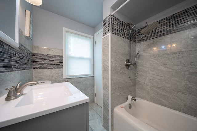 full bathroom with tile walls, shower / bath combination, and vanity