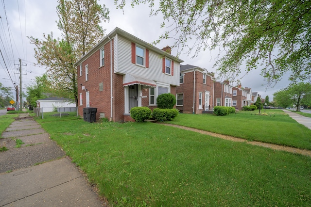 view of front of home with a chimney and brick siding
