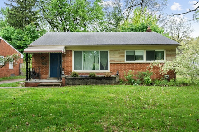 view of front facade featuring a front lawn, brick siding, and a chimney