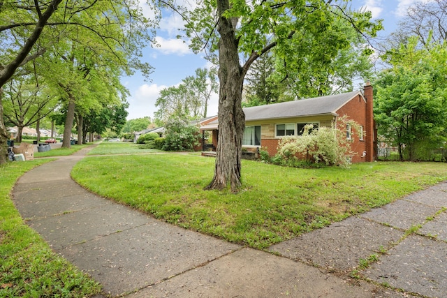 view of property exterior with a chimney and brick siding