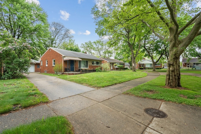 ranch-style house with brick siding and a front yard