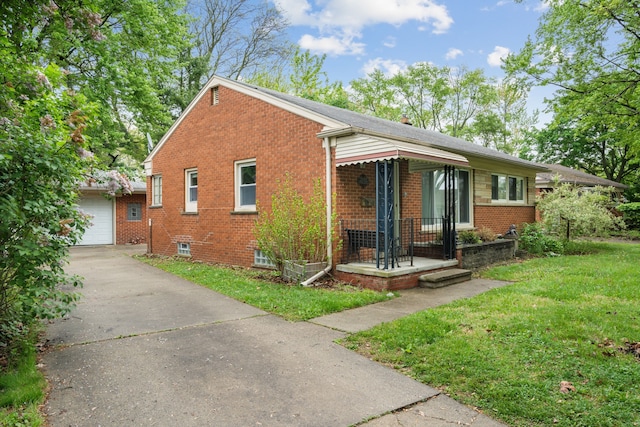 view of front of property with brick siding, a front lawn, concrete driveway, and a garage