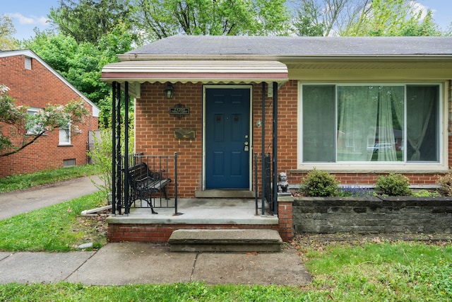 view of front of property with brick siding and a shingled roof
