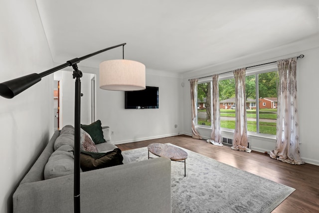 living area with dark wood finished floors and baseboards