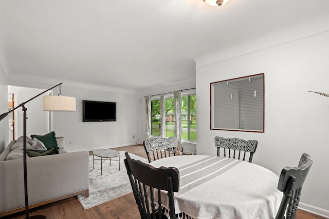 dining area featuring wood finished floors and baseboards