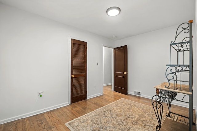 office space with wood finished floors and baseboards