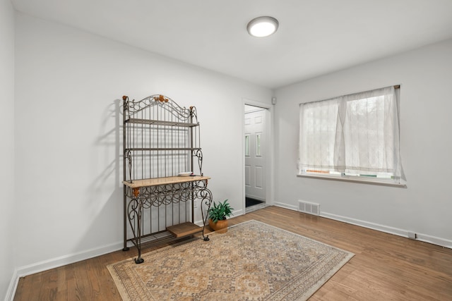 interior space featuring baseboards and wood finished floors