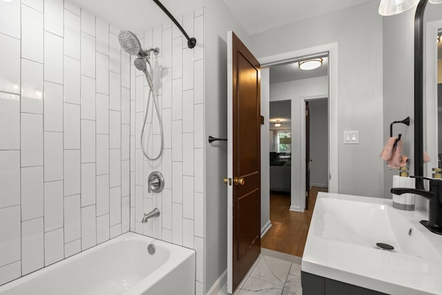 full bath with shower / bath combination, baseboards, marble finish floors, and vanity