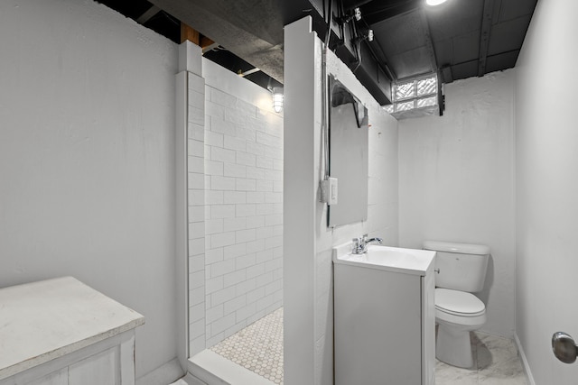 full bath with toilet, tiled shower, vanity, and marble finish floors