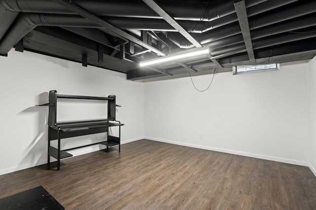 finished basement featuring wood finished floors and baseboards