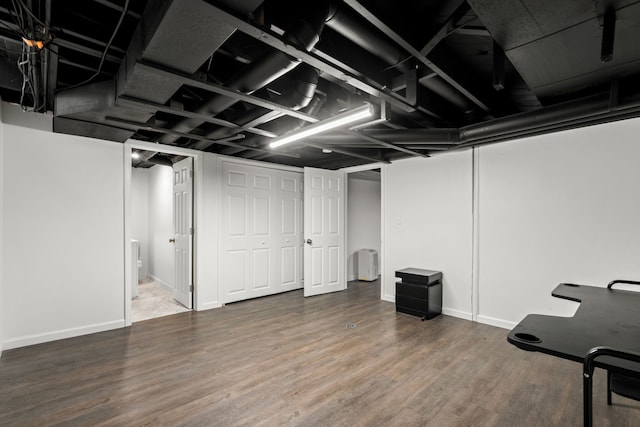 finished below grade area with wood finished floors and baseboards