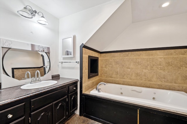 bathroom with a jetted tub and vanity