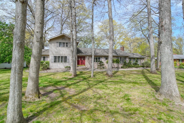 216 Wickenham Dr, Spring Arbor, MI 49283 - view of front of home featuring a chimney and a front lawn