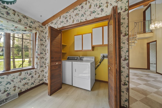 216 Wickenham Dr, Spring Arbor, MI 49283 - clothes washing area featuring cabinet space, wallpapered walls, separate washer and dryer, baseboards, and a chandelier