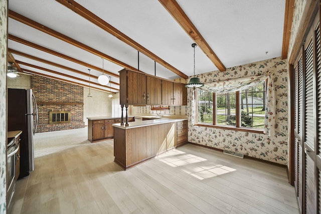216 Wickenham Dr, Spring Arbor, MI 49283 - kitchen featuring a peninsula, wallpapered walls, light wood finished floors, stainless steel appliances, and light countertops