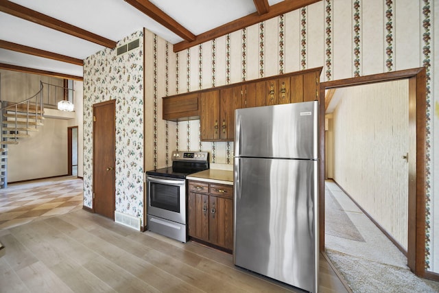216 Wickenham Dr, Spring Arbor, MI 49283 - kitchen featuring stainless steel appliances, wallpapered walls, beamed ceiling, light wood-type flooring, and light countertops