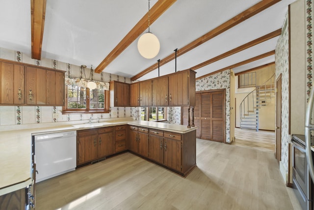 216 Wickenham Dr, Spring Arbor, MI 49283 - kitchen with white dishwasher, light wood-style flooring, light countertops, brown cabinets, and wallpapered walls