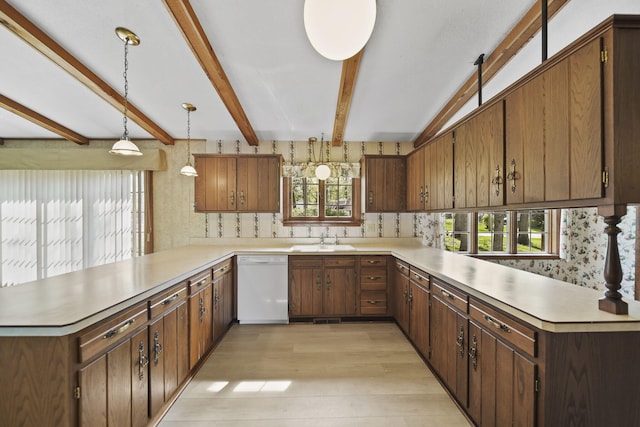216 Wickenham Dr, Spring Arbor, MI 49283 - kitchen with white dishwasher, a peninsula, a sink, light wood-style floors, and light countertops