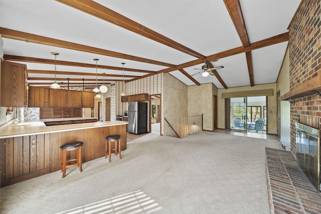 216 Wickenham Dr, Spring Arbor, MI 49283 - unfurnished living room featuring light colored carpet, a brick fireplace, a ceiling fan, and a sink