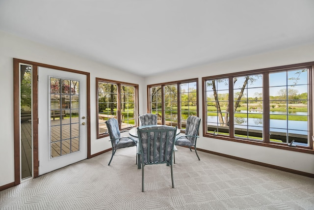 216 Wickenham Dr, Spring Arbor, MI 49283 - sunroom / solarium featuring baseboards, carpet floors, and a water view