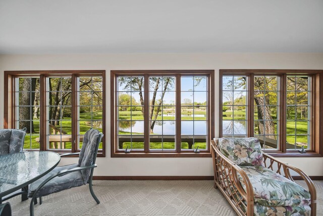 216 Wickenham Dr, Spring Arbor, MI 49283 - sunroom / solarium featuring baseboards and a water view