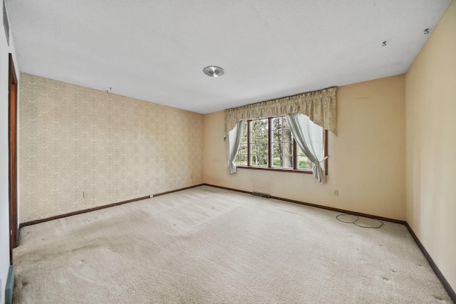 216 Wickenham Dr, Spring Arbor, MI 49283 - carpeted empty room with baseboards and wallpapered walls